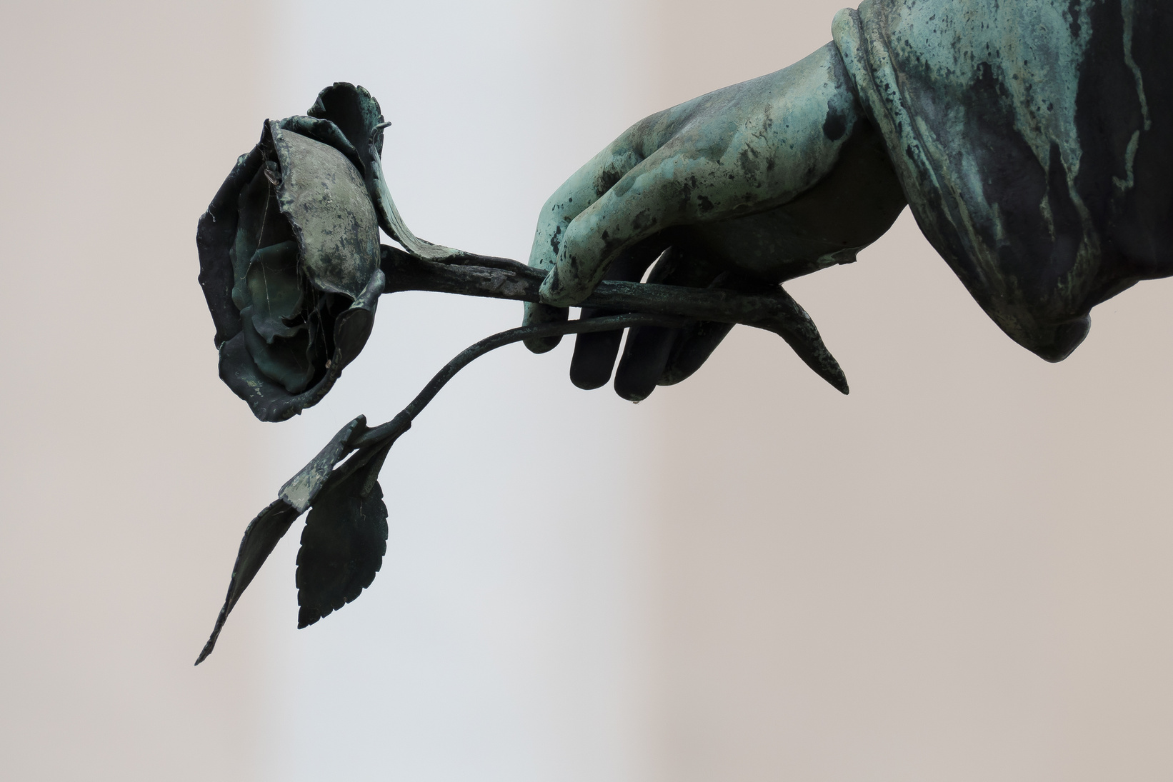 Sculpture of an Angel's Hand Holding a Rose
