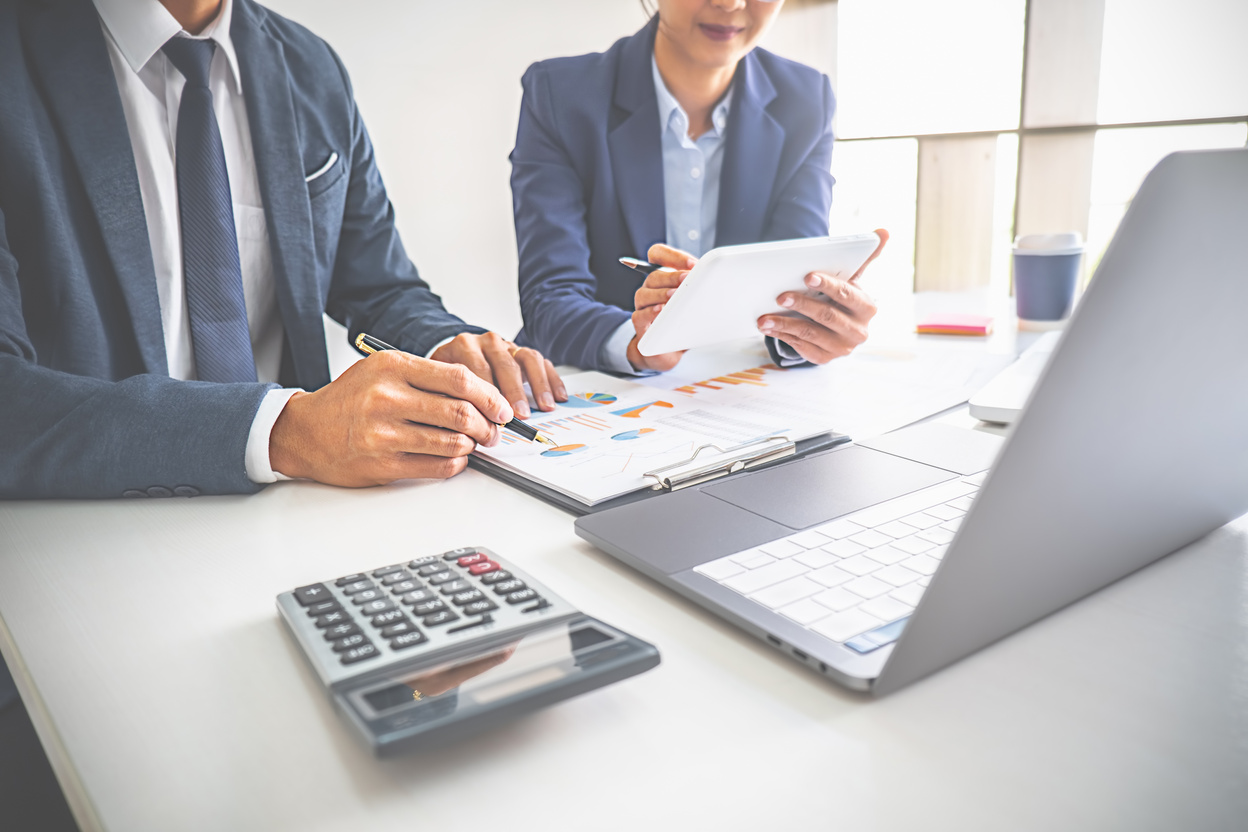 Professionals Working with Reports on Workplace Table