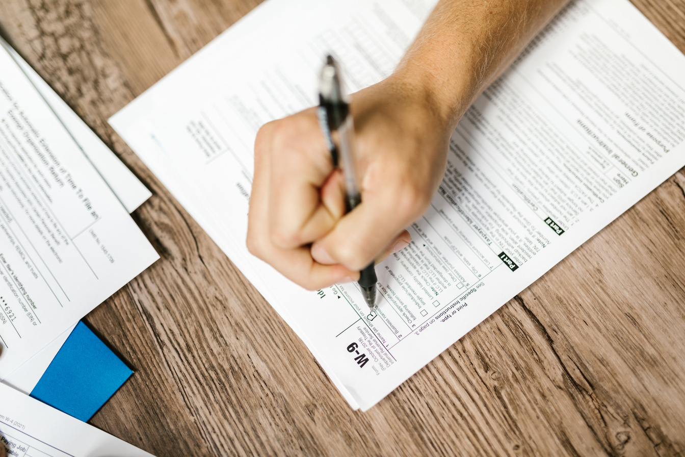 Close-Up Shot of a Person Filling Out a Form