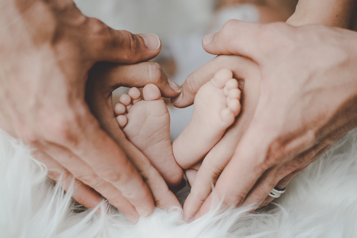 Person Holding Baby's Feet